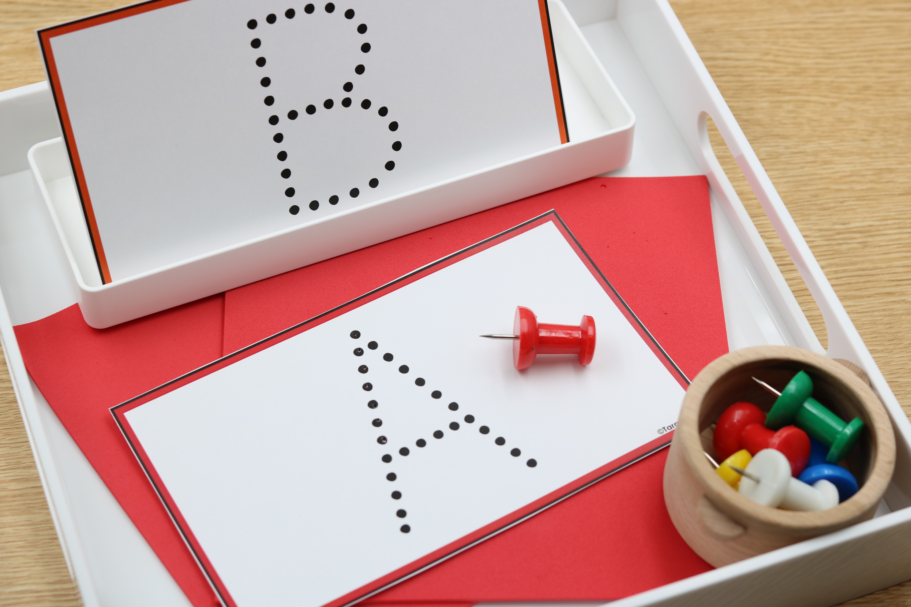Alphabet fine motor center featuring dotted uppercase letter formation cards with push pins for hands-on letter recognition and formation practice.