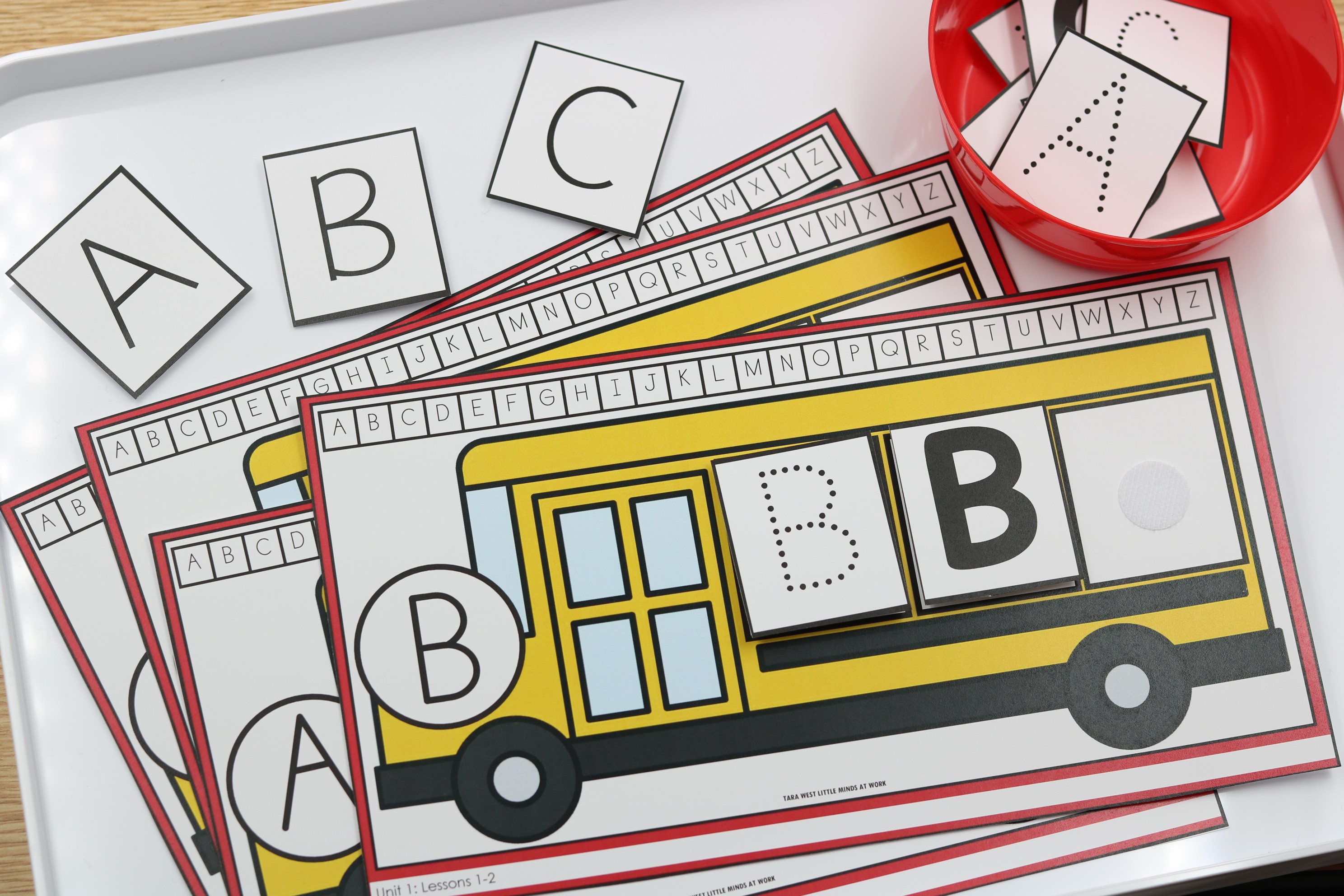 Back-to-school alphabet center featuring school bus letter matching mats with uppercase letter cards and dotted letter formation cards for hands-on alphabet practice.