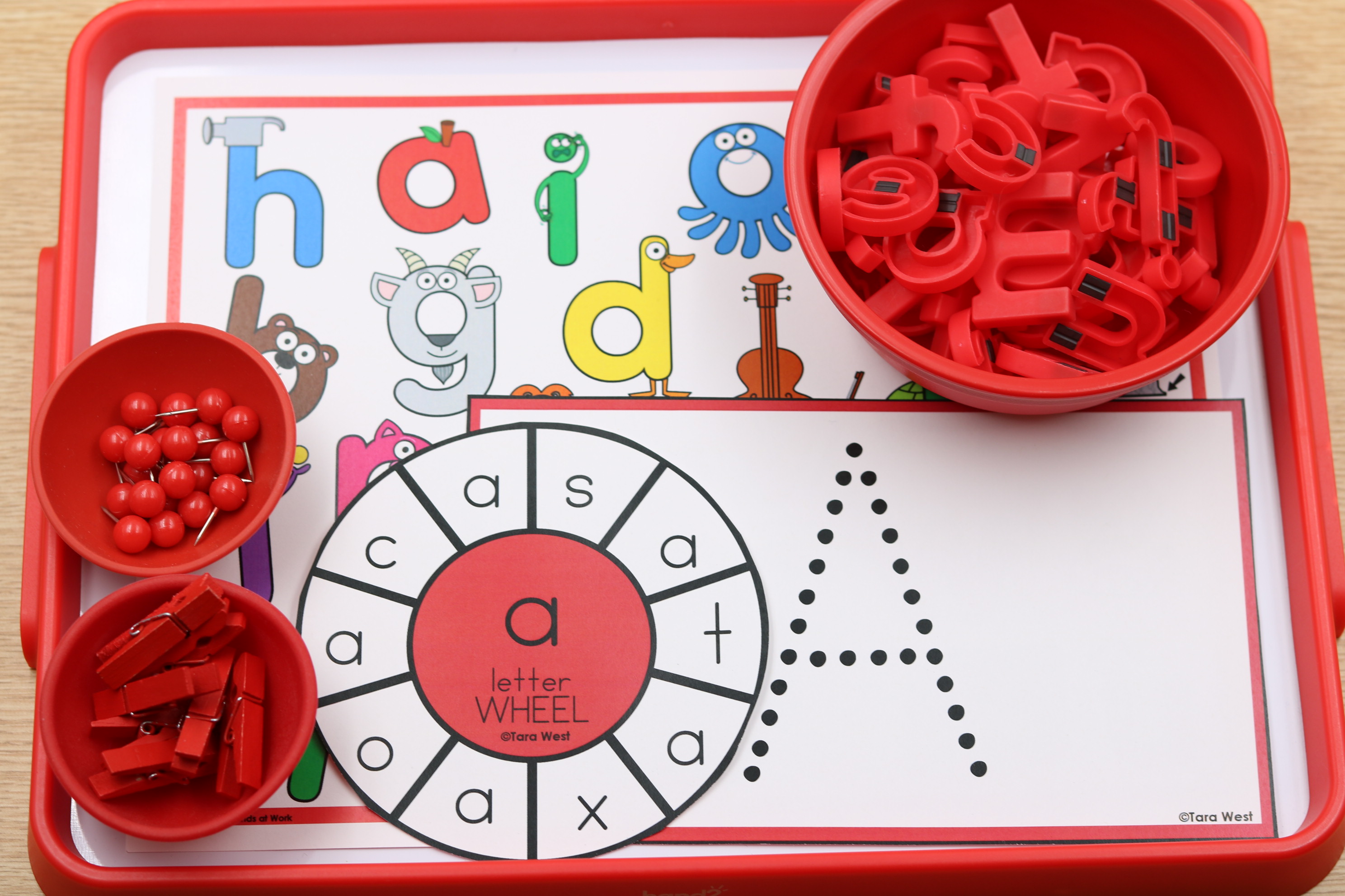 Back-to-school alphabet center featuring letter A recognition and formation activities with a letter wheel, magnetic letters, mini clothespins, push pins, and a dotted letter tracing mat.