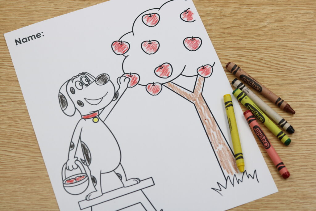 FREE apple themed kindergarten coloring sheet featuring Pip the Pup picking apples for a fun back to school fine motor activity.
