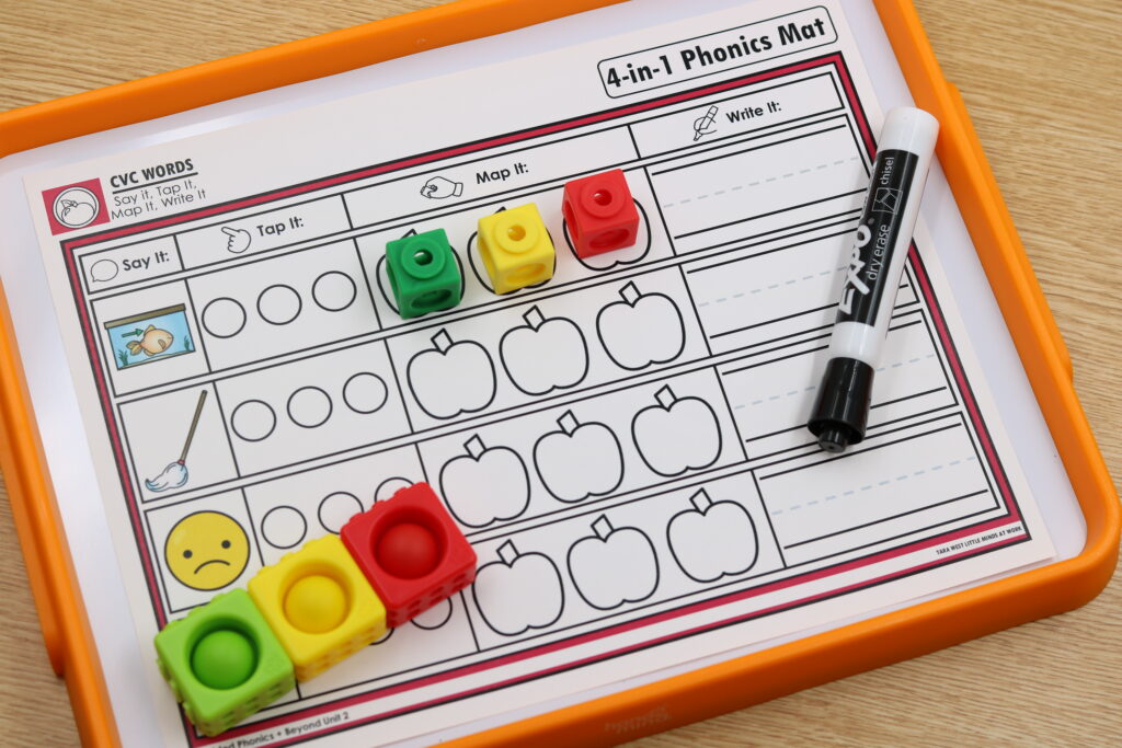 Close-up of apple-themed phonics mat with sound boxes filled in