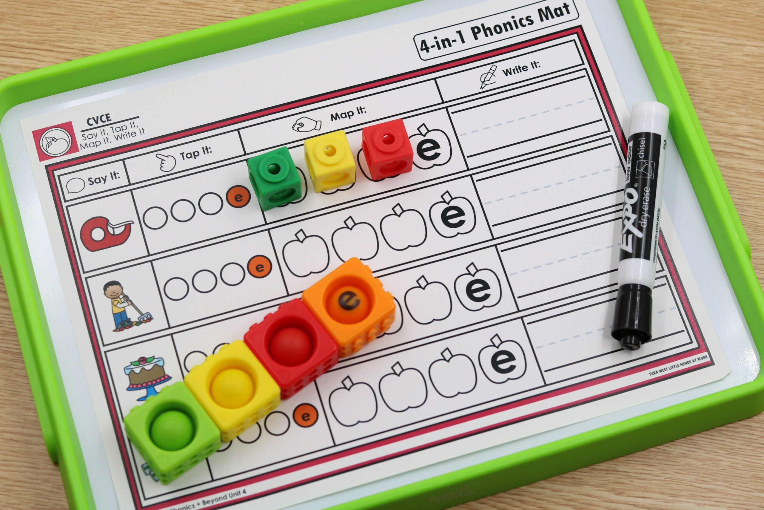 A setup of multiple apple-themed mats for CVCe words at a small-group table