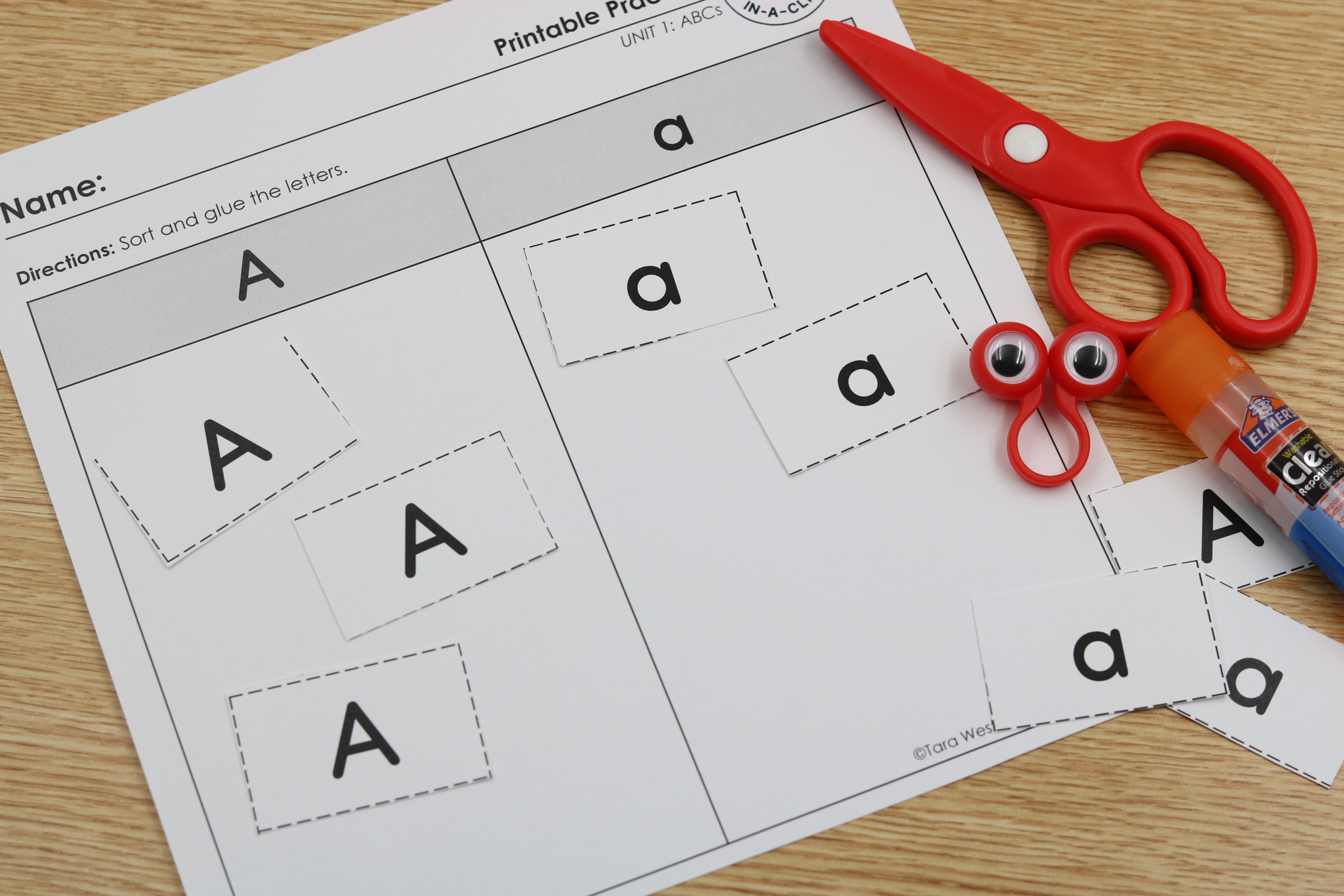 Students alphabet cut and sort letters sorting capital and lowercase A.