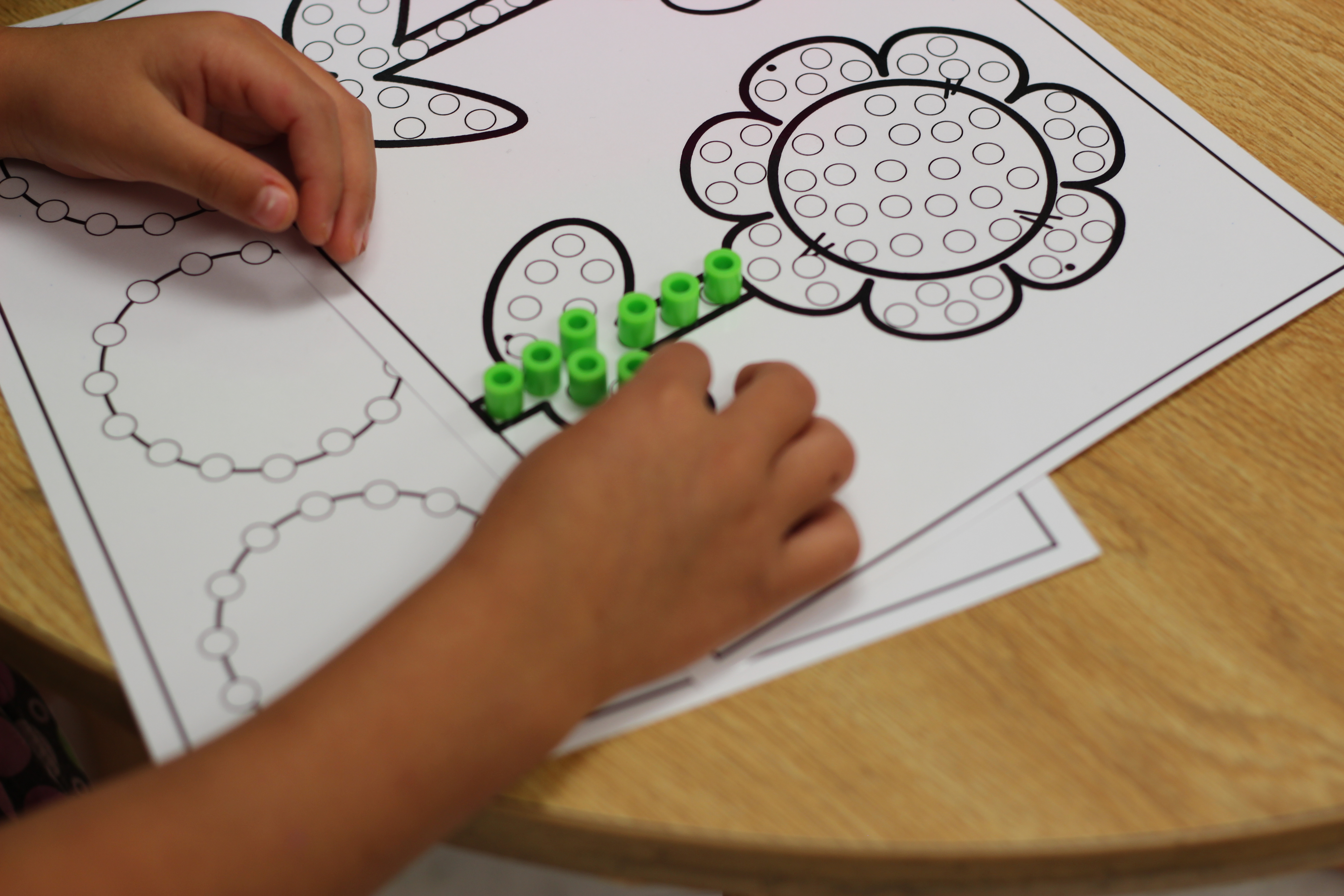 Free fine motor perler bead mats as students build a flower.