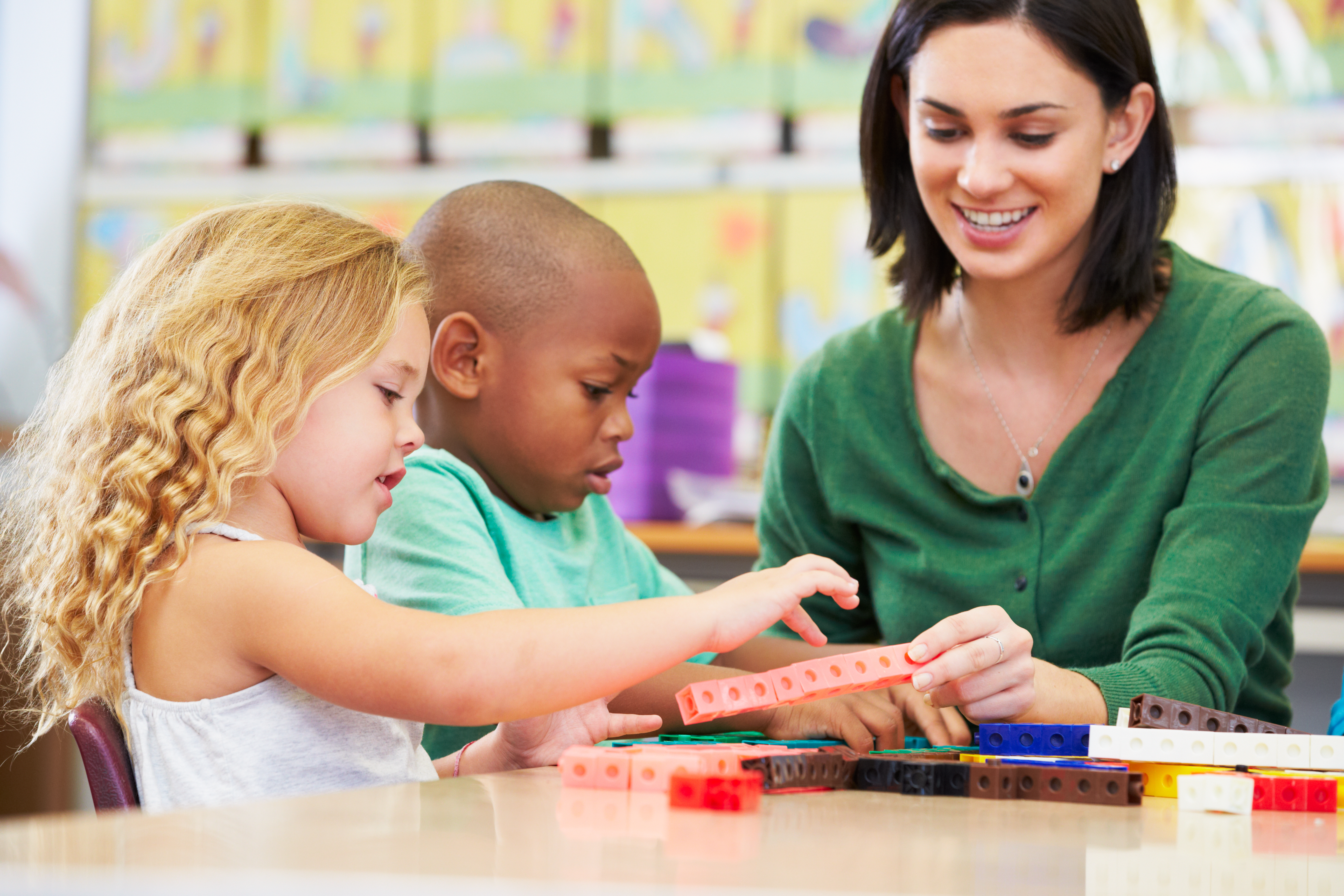 Teacher using number sense activities with young learners to build counting, subitizing, number relationships, and early math skills through hands-on learning.
