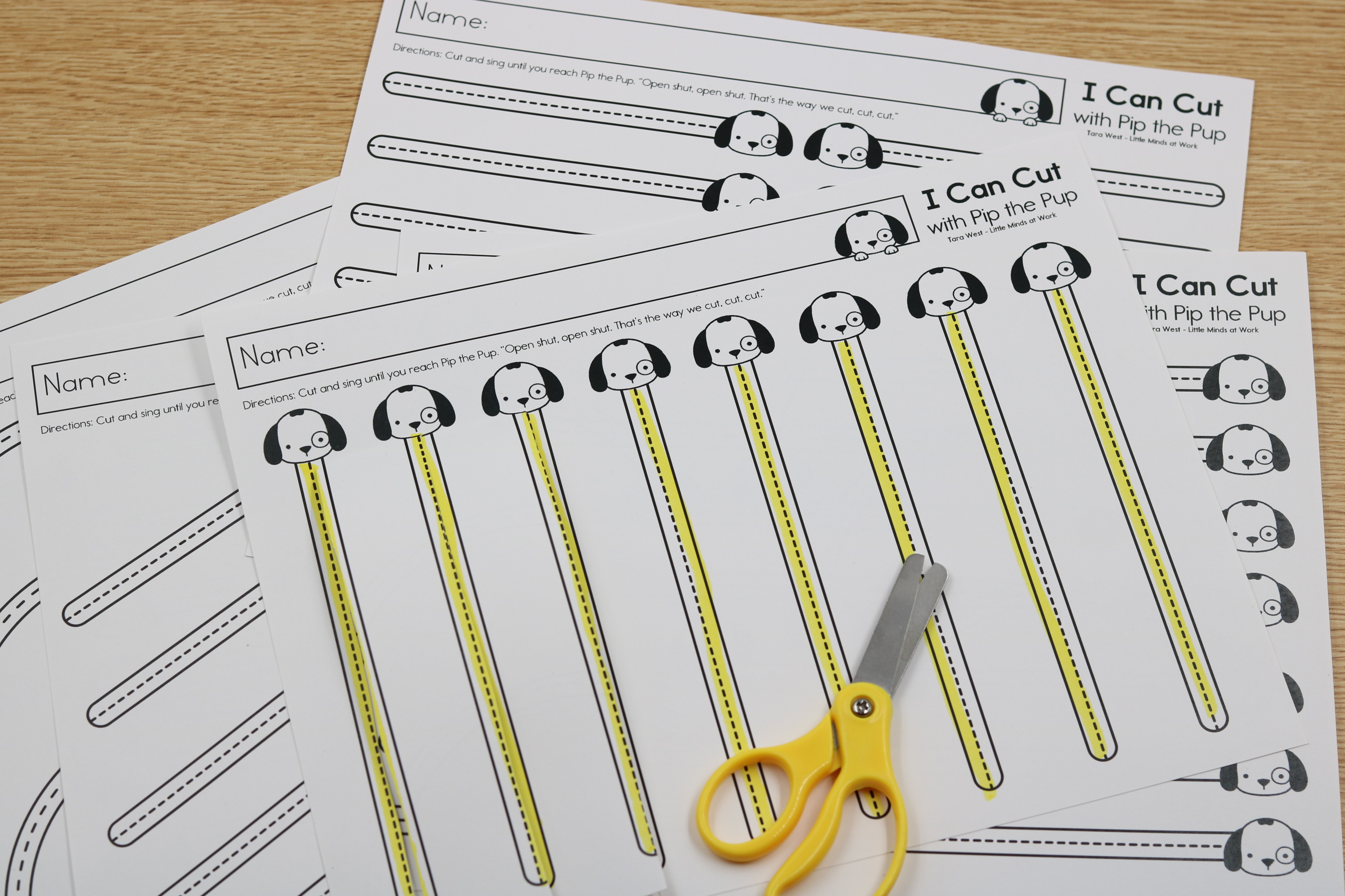 Pip the pup free cutting printables student cuts straight lines with yellow scissors.