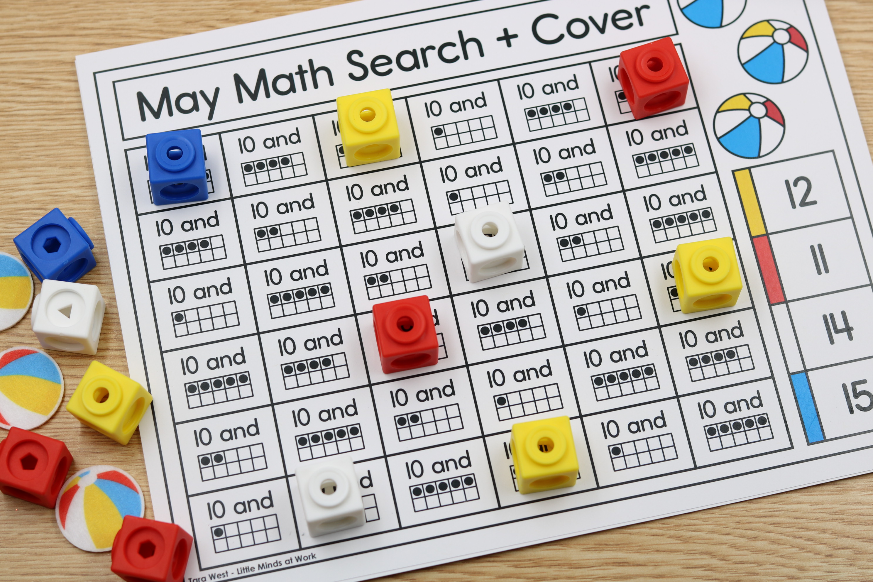 Kindergarten student playing May summer teen number math search and cover center.
