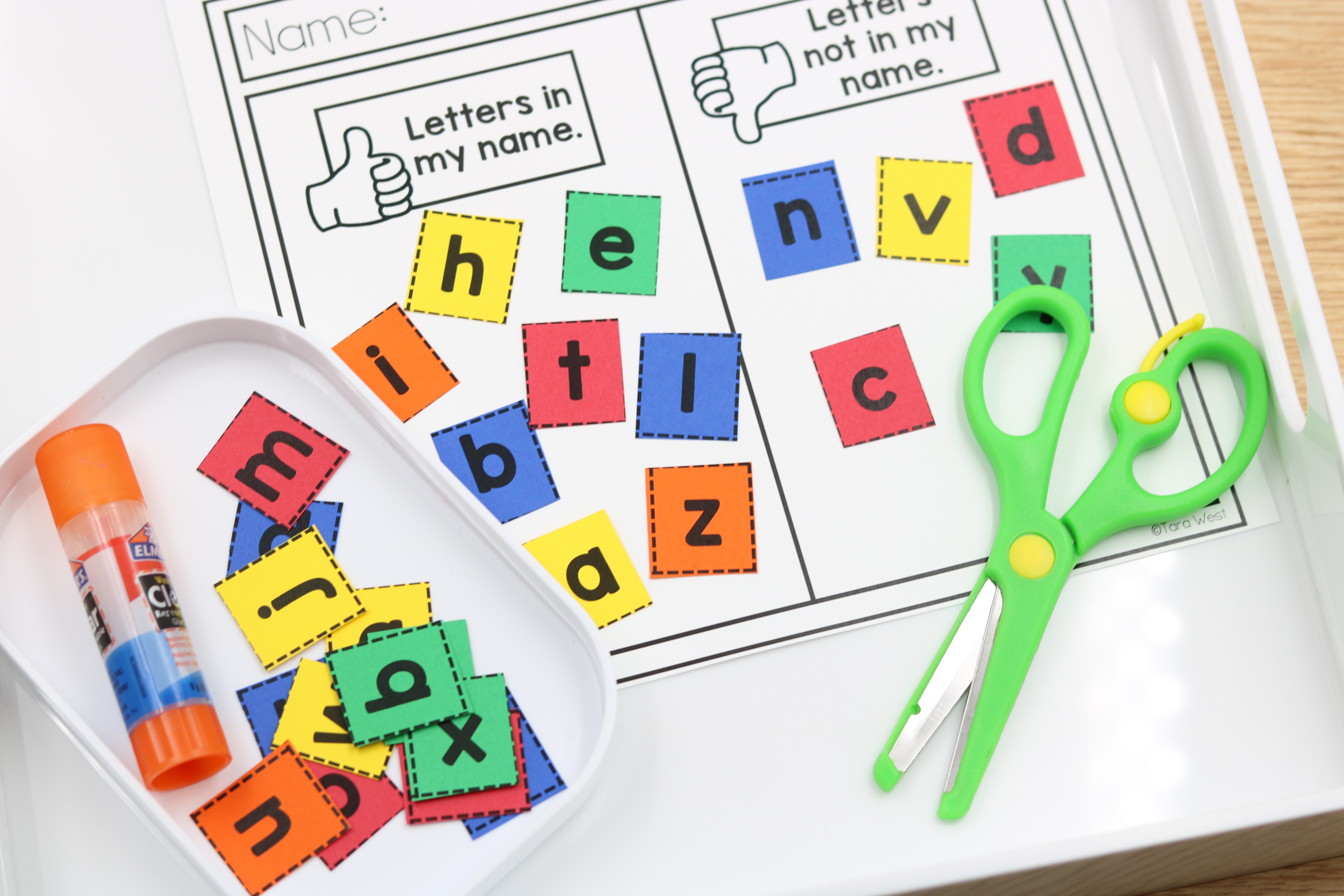 Letter sorting worksheet grouping alphabet letters by shape features like holes and curves.